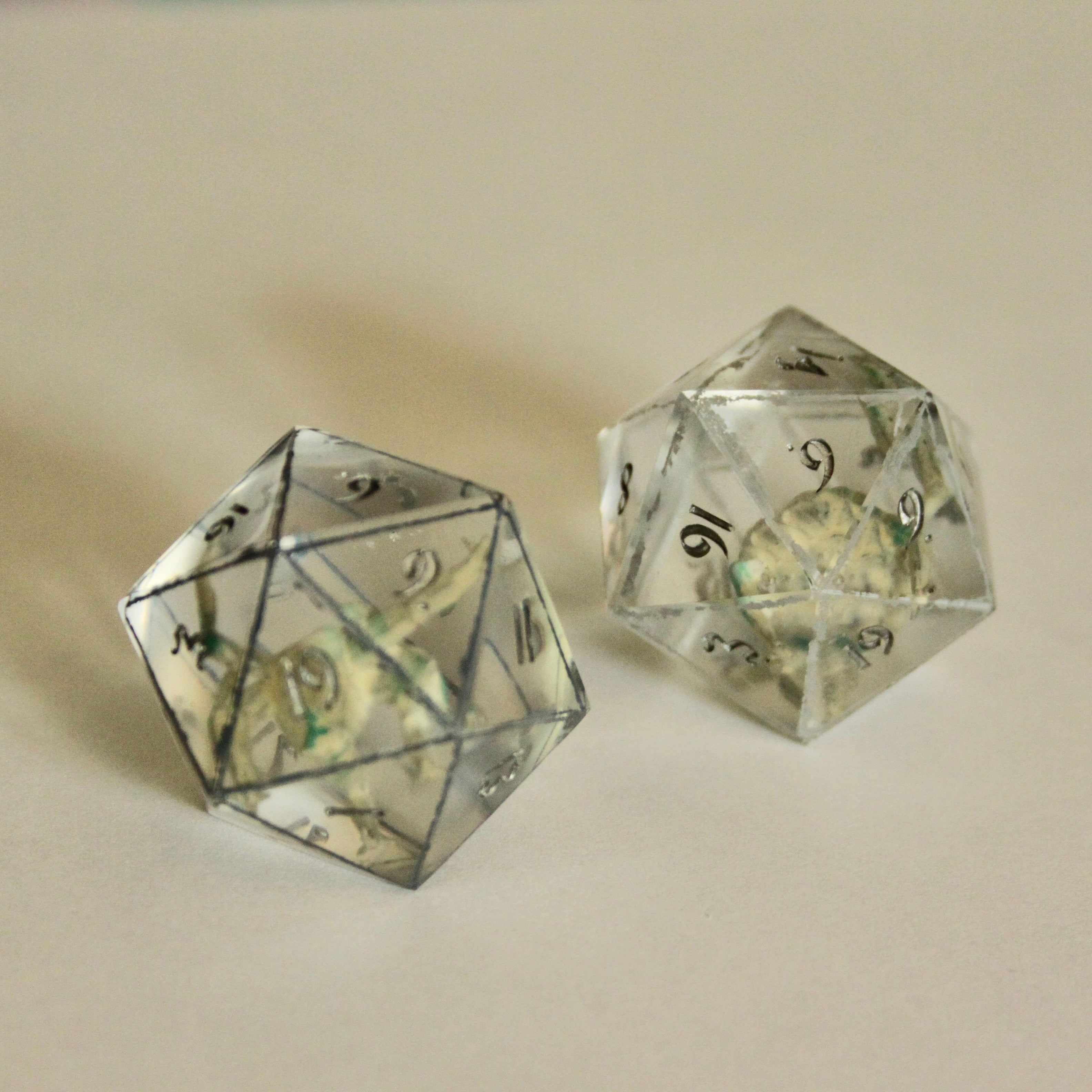 Rocky d20 with dark grey (left) and light grey (right) painted border.