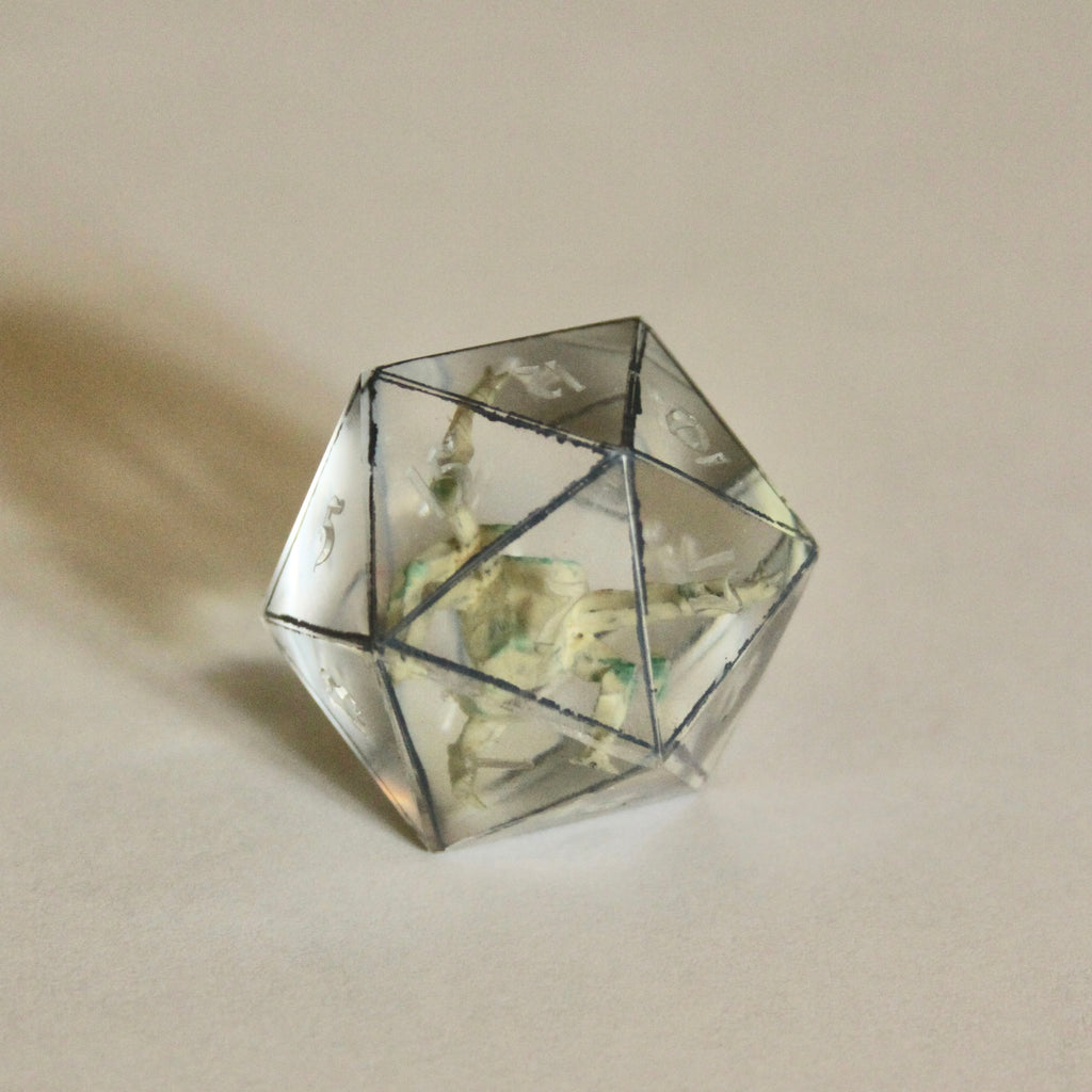 Rocky d20. The numbers in this one aren't painted yet so you can see the miniature figure better in the picture.